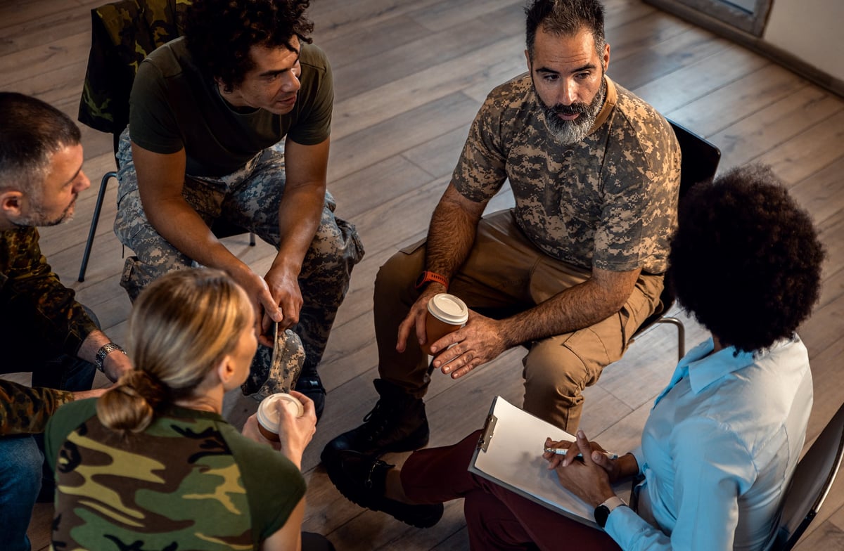 A diverse group of Veterans supporting one another in a peer support circle