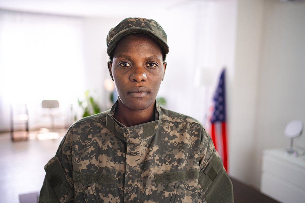 A confident African American woman in military uniform, representing the diversity of those who served